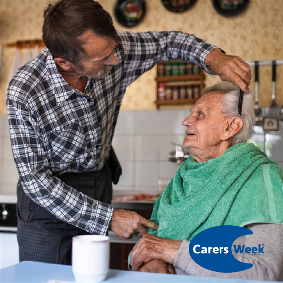 Photo of son cutting his elderly father\\\\\\\\\\\\\\\'s hair as a carer