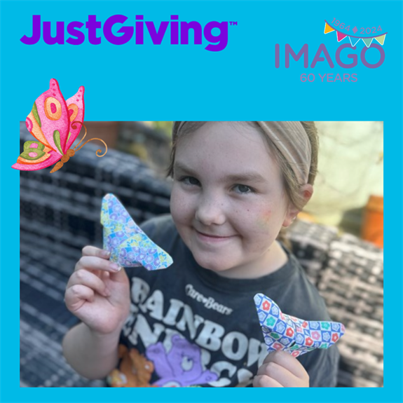 photo of esmae holding up two origami paper butterflies